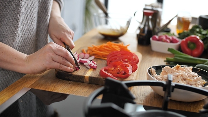 radishes being sliced on a chopping board