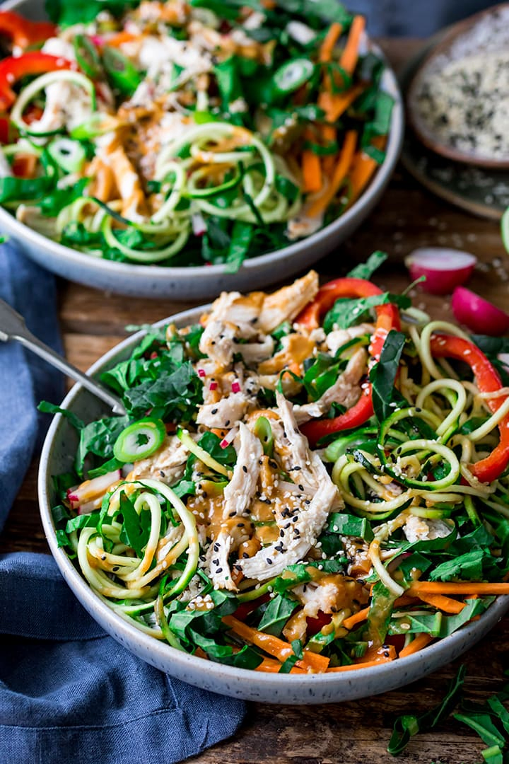chicken zoodle salad in a bowl with Thai peanut sauce