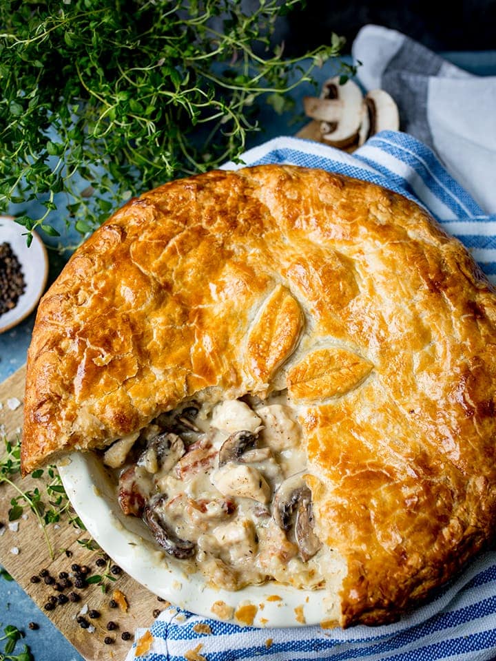 Overhead image of chicken and mushroom pie with a slice taken out