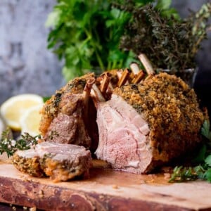 Square image of Herb crusted roasted rack of lamb with a slice taken out