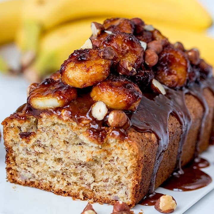 Banana bread with caramelized bananas one a white background