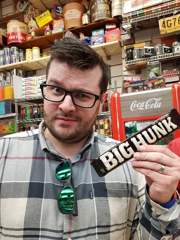 Chris posing with a big hunk candy bar