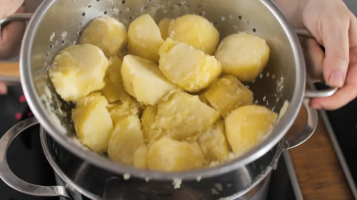 Boiled Potatoes being shaken in a colander