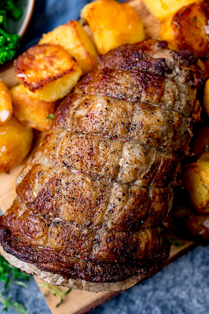 Overhead of joint of roast beef with roast potatoes