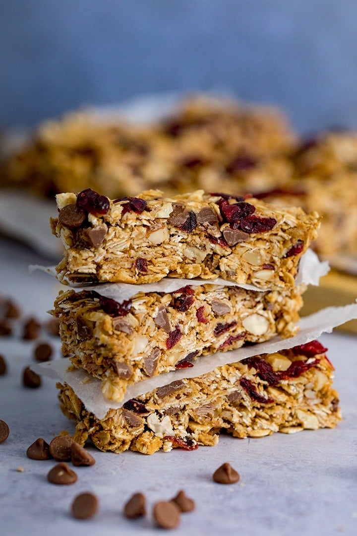 3 stacked Peanut Butter Granola Bars with more granola bars in the background