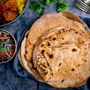 Stack of Chapati on a plate on blue background