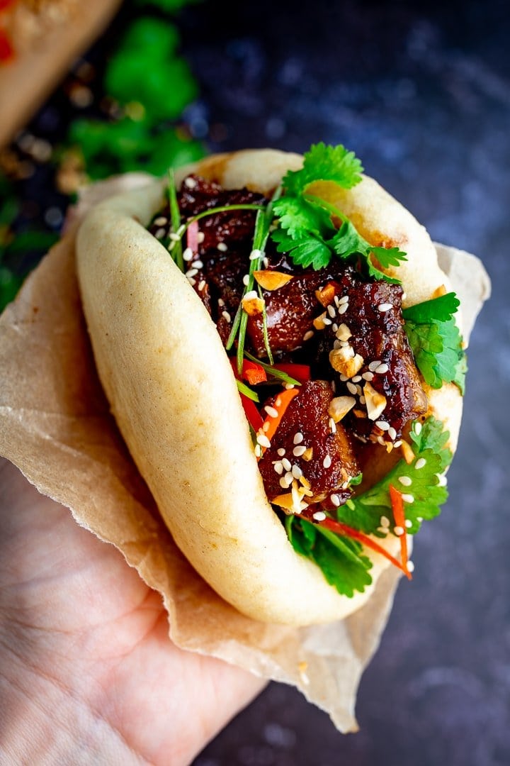 Hand holding Gua Bao pork belly bun