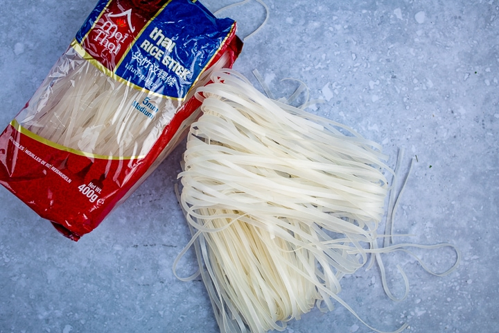 Dry flat rice noodles on a blue background