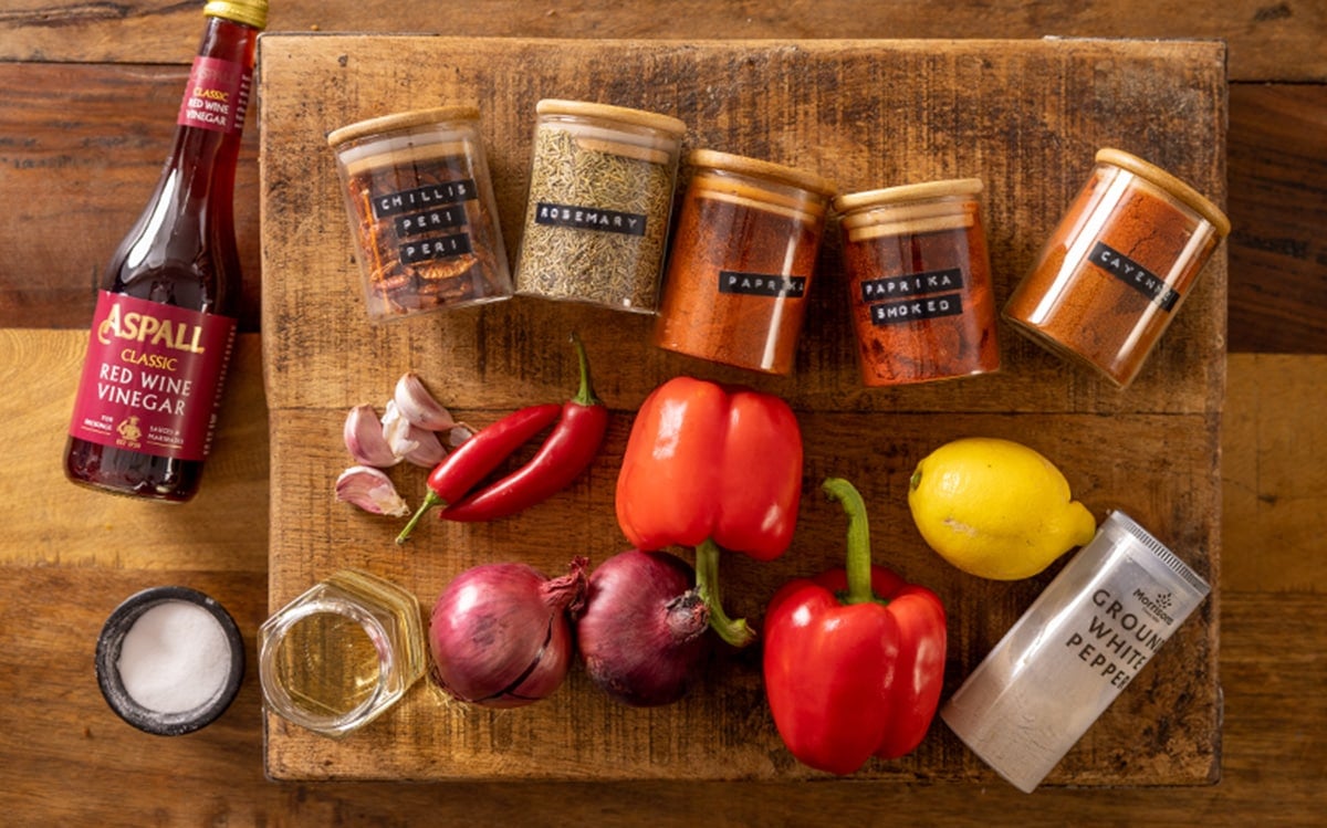 Ingredients for homemade peri peri sauce on a wooden table