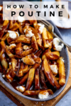 Poutine in a grey dish on a wooden board with text overlay