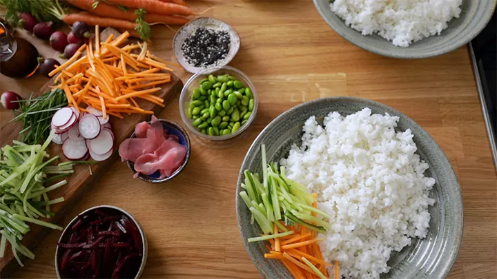 Overhead image of assembling a sushi salmon bowl