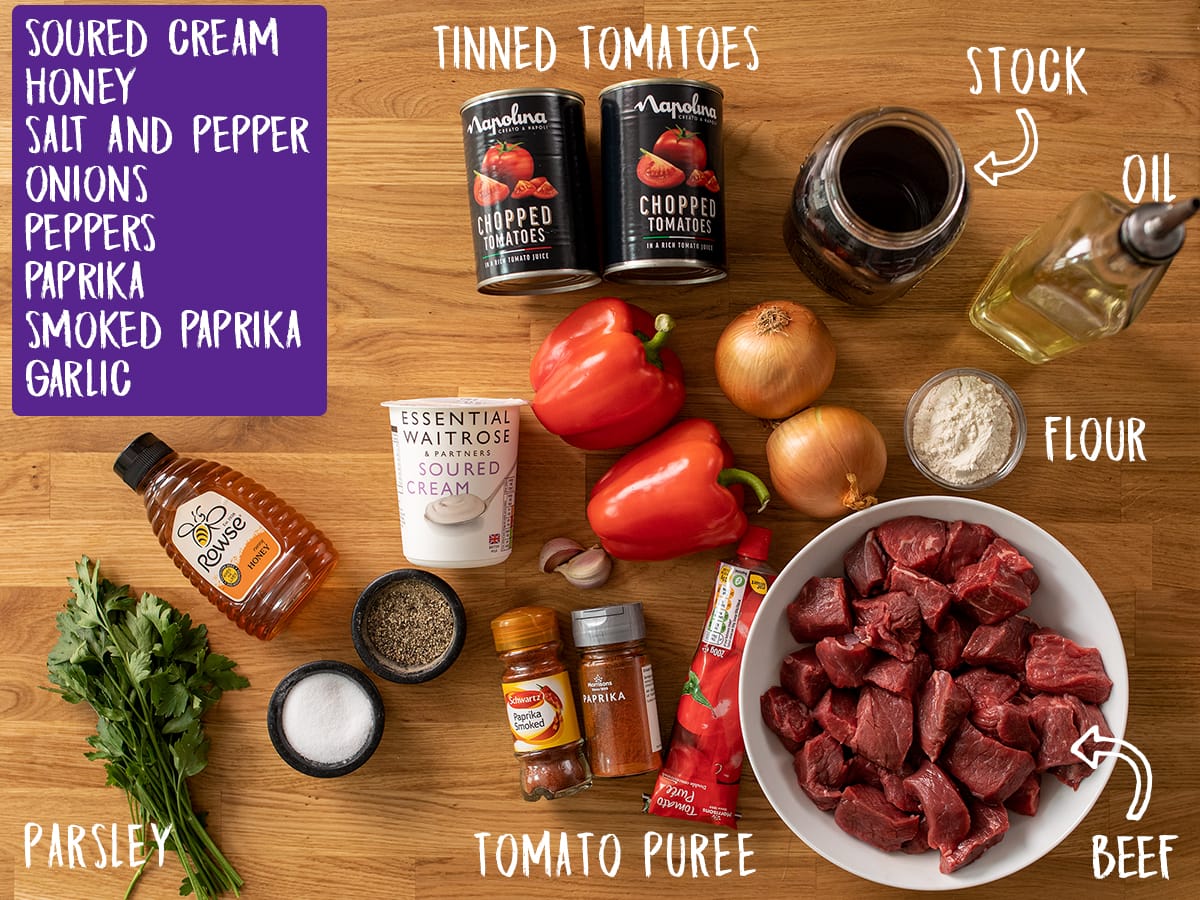 Ingredients for Beef Goulash on a wooden table