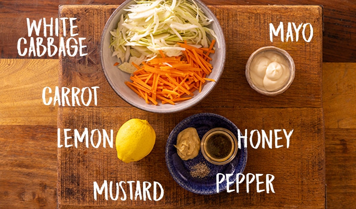 Ingredients for honey mustard coleslaw on a wooden table