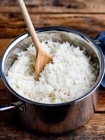 Wooden spoon in a pan of boiled rice
