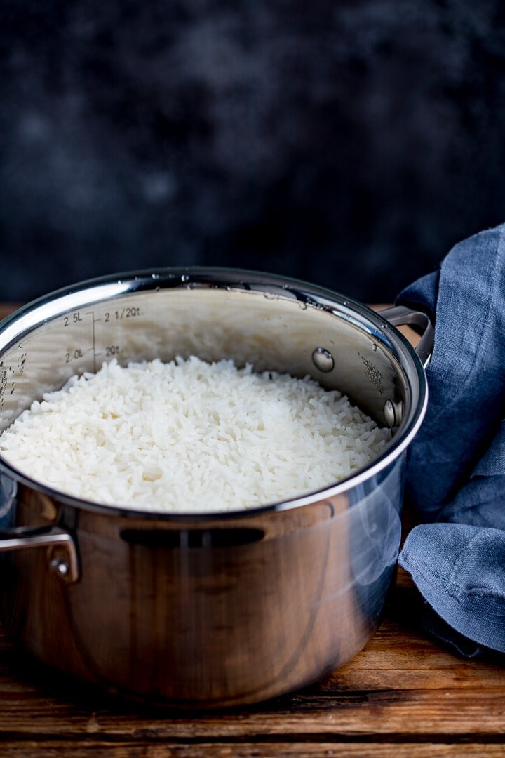Boiled rice in a pan on a dark background