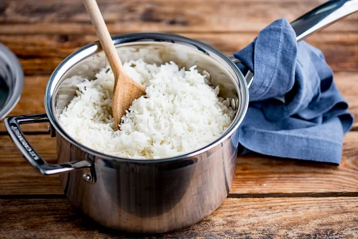 Wide image of boiled rice in a pan