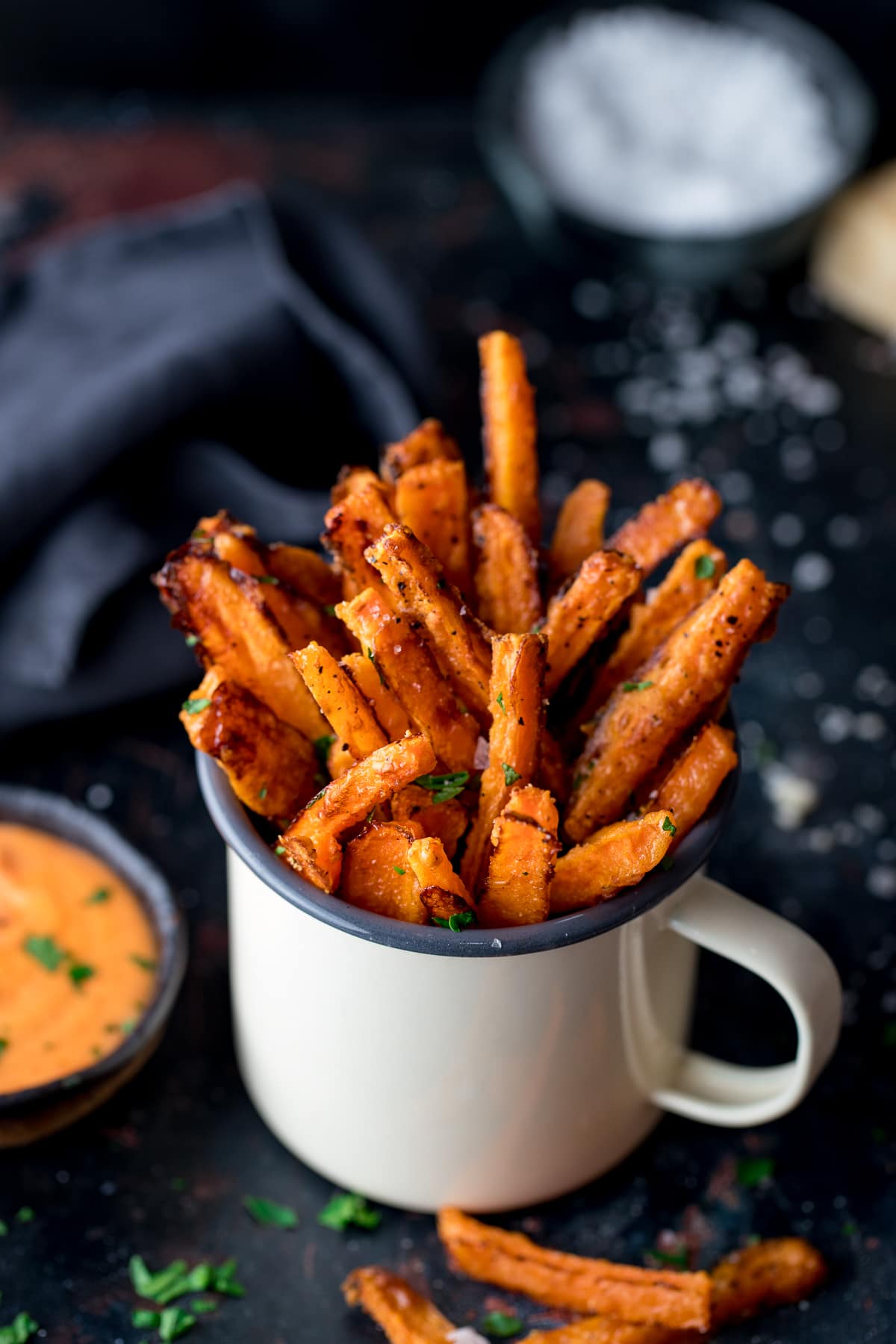 Carrot fries in a white enamel mug