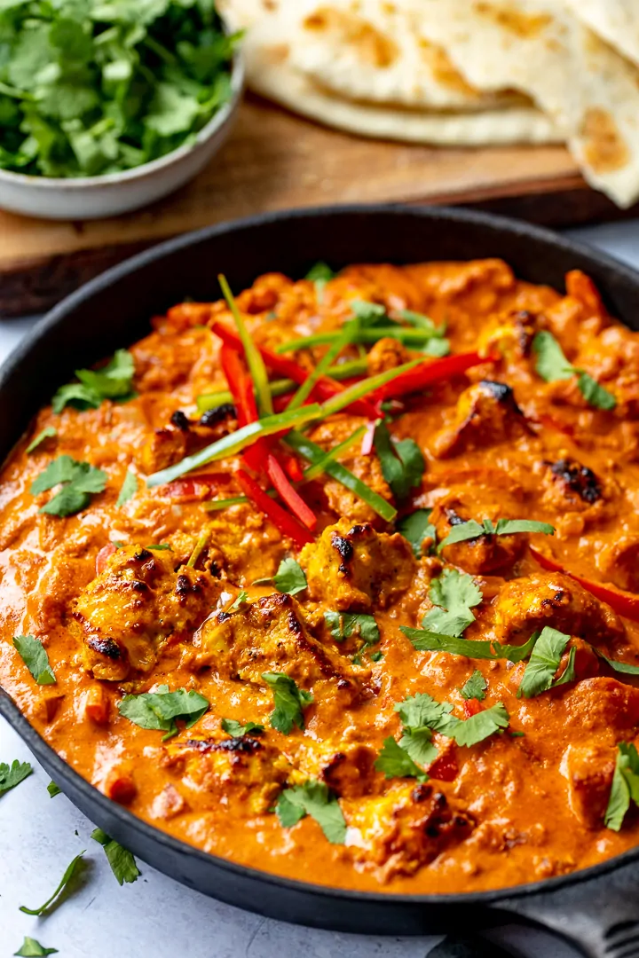 Pan of chicken tikka masala on a light background