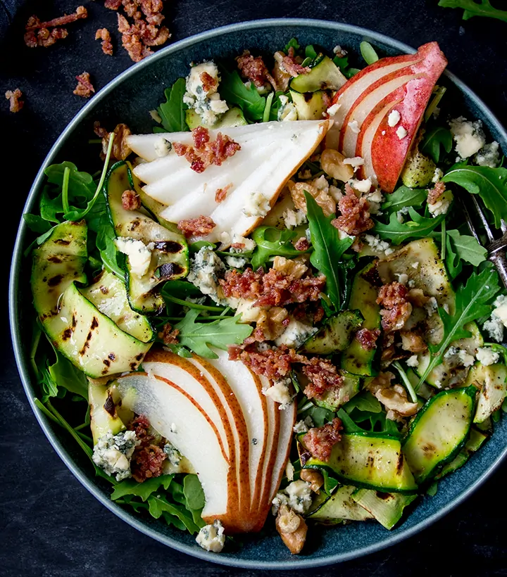 Grilled Zucchini, Stilton and Pear Salad on a dark background