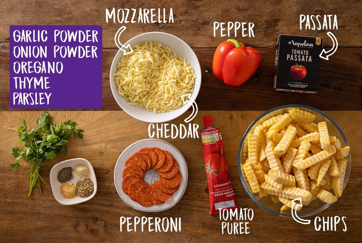 Ingredients for pizza fries on a wooden table