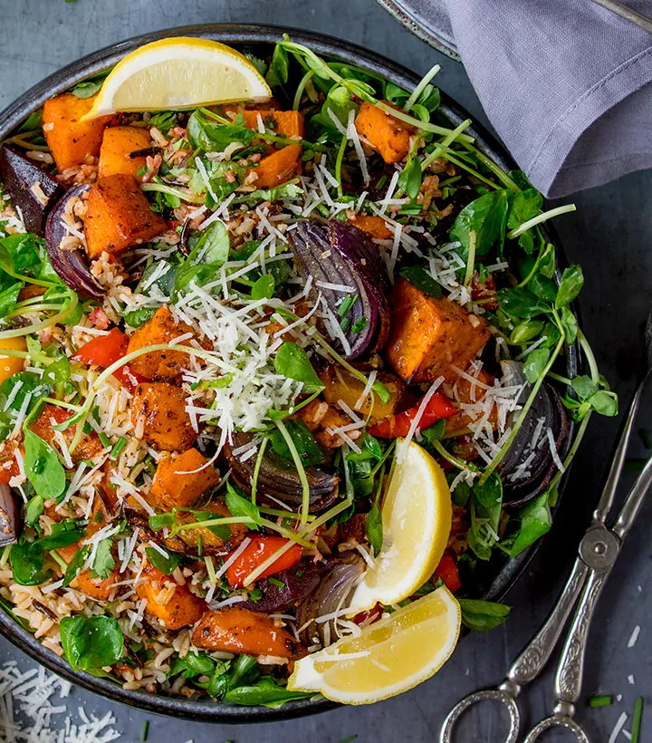 Overhead of Roasted Vegetable and Herby Wild Rice Salad with a pair of salad tongs to the side