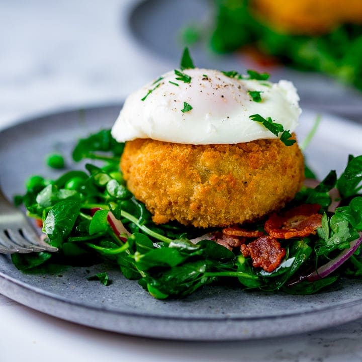 pea and bacon salad topped with a fish cake and poached egg