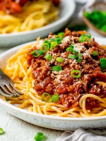 Plate of spaghetti bolognese on a light background