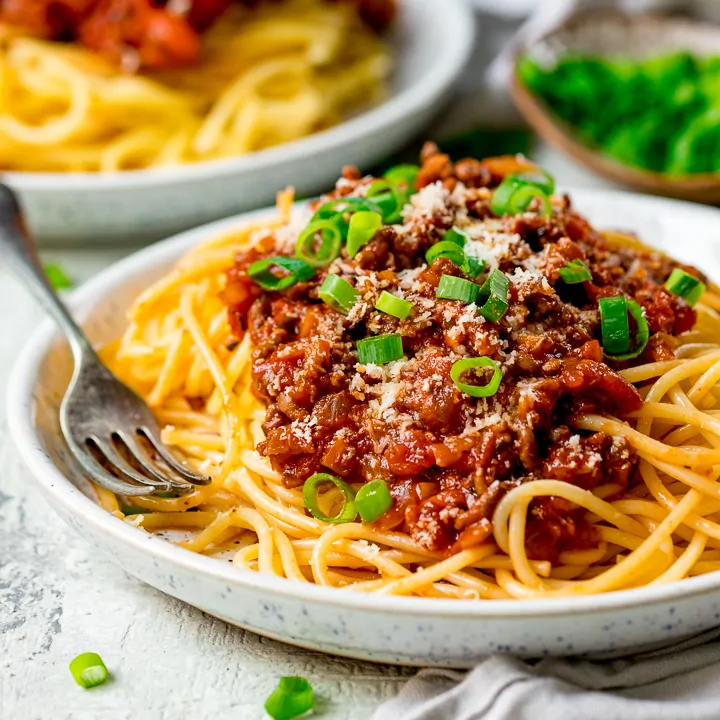 Plate of spaghetti bolognese on a light background