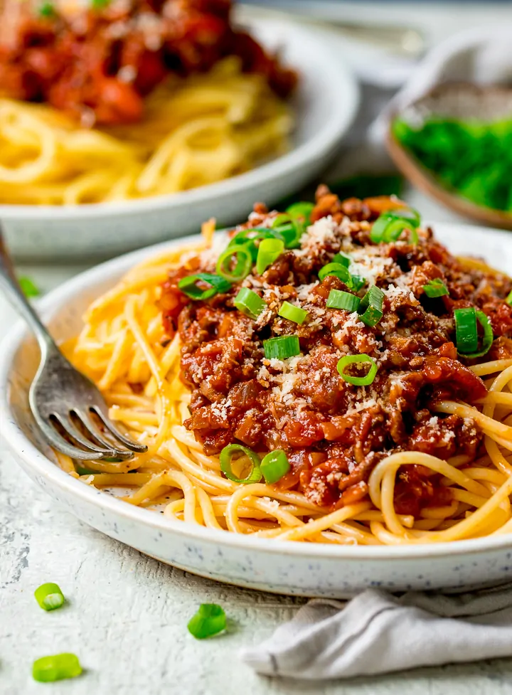 spaghetti bolognese on a white plate, on a light background