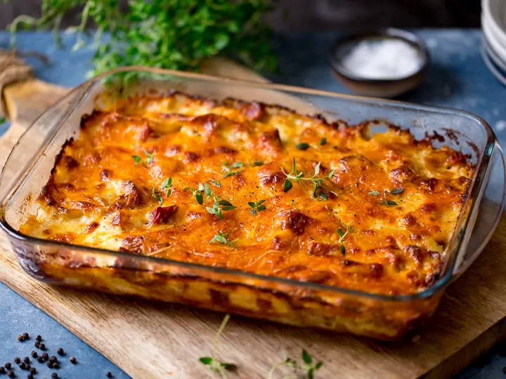 wide image of Scalloped potatoes with ham in a dish