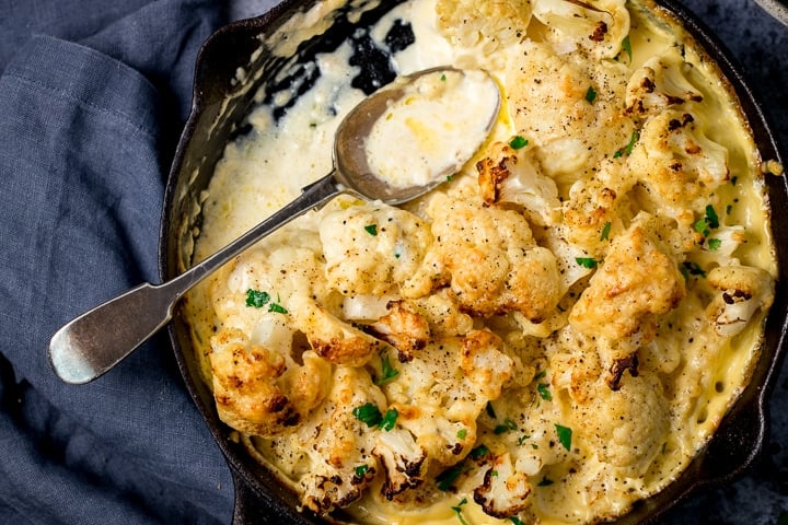 Cauliflower cheese in a pan on a dark background