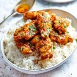 honey garlic chicken in a bowl on top of boiled rice