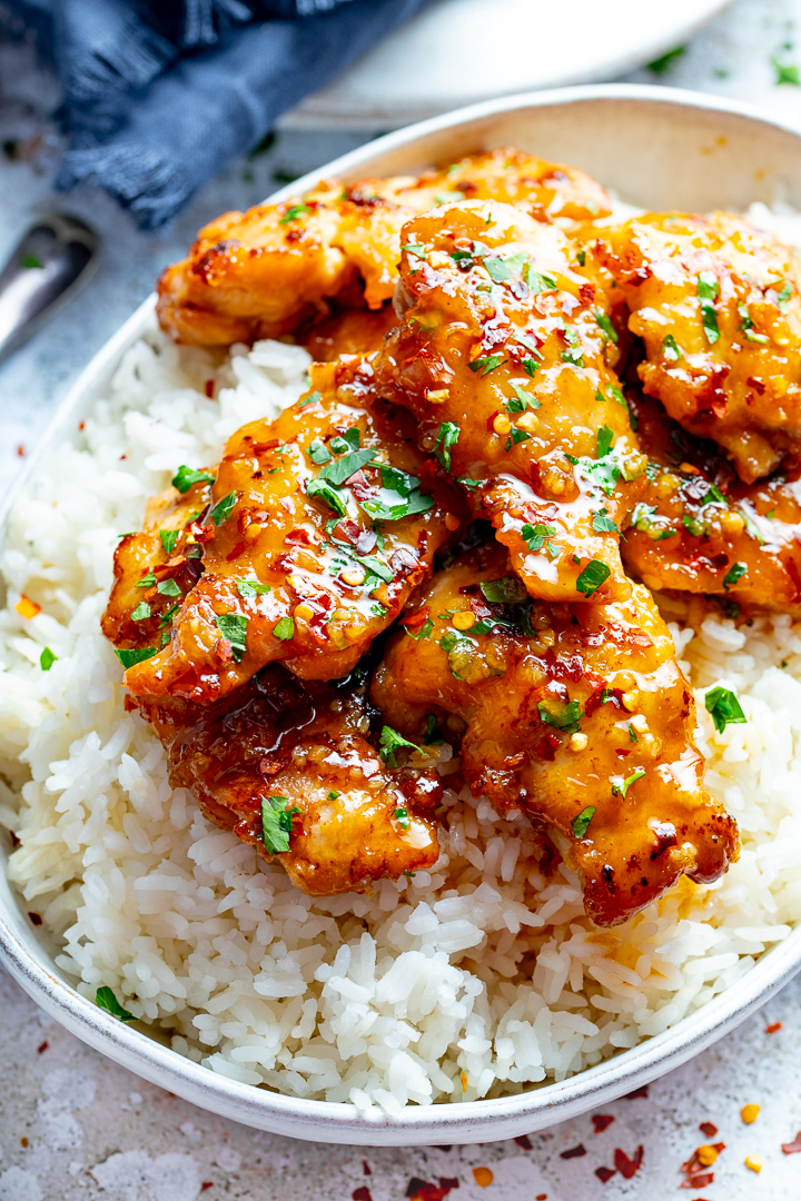 honey garlic chicken on boiled rice in a bowl