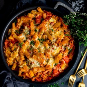 Overhead image of leftover turkey, ham and cheese pasta bake in a black pan