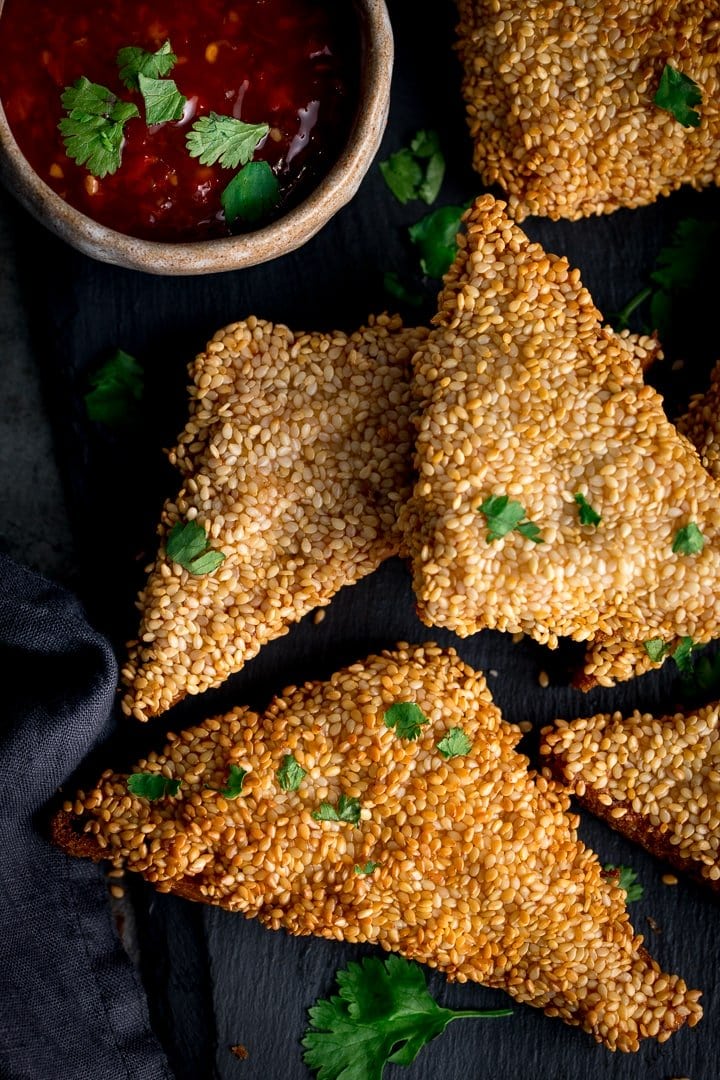 Overhead of prawn toast and sweet chilli sauce on dark background