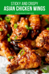 Sticky Asian Chicken Wings piled up with spring onions on top