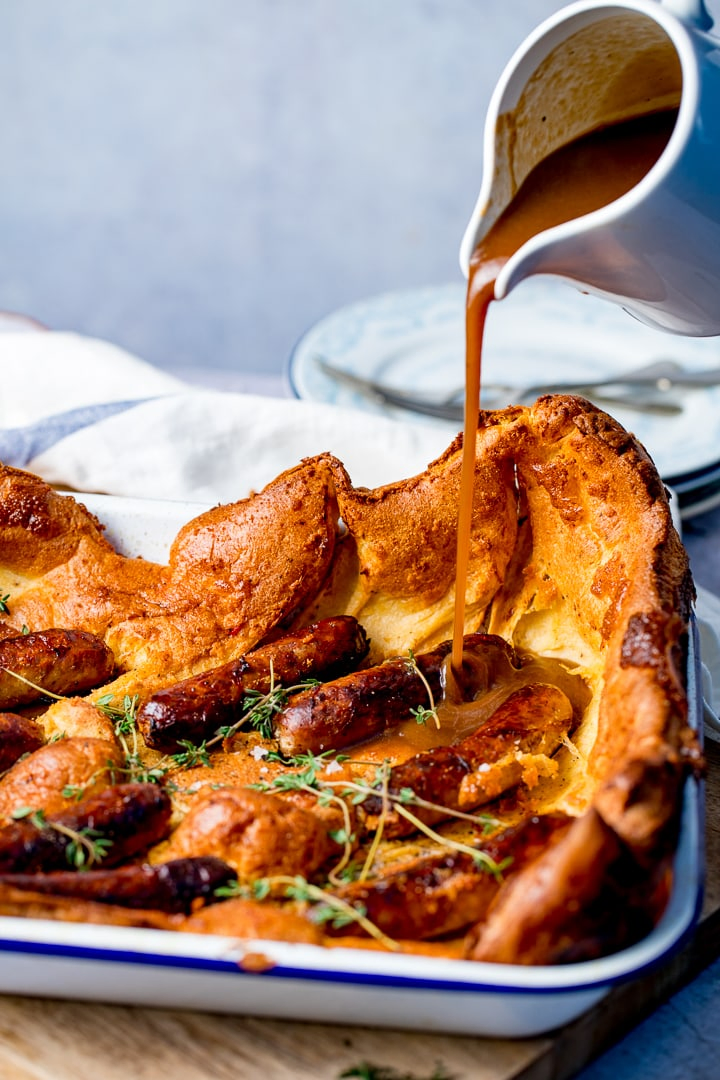 Gravy being poured on toad in the hole