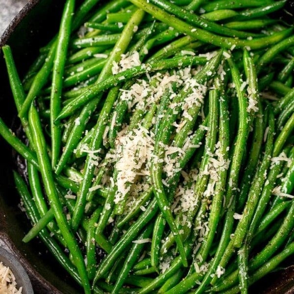 green beans sprinkled with parmesan in a pan