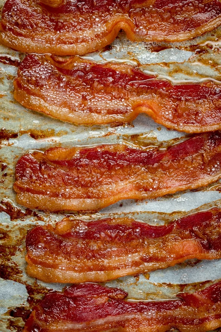 Overhead image of cooked bacon on a tray