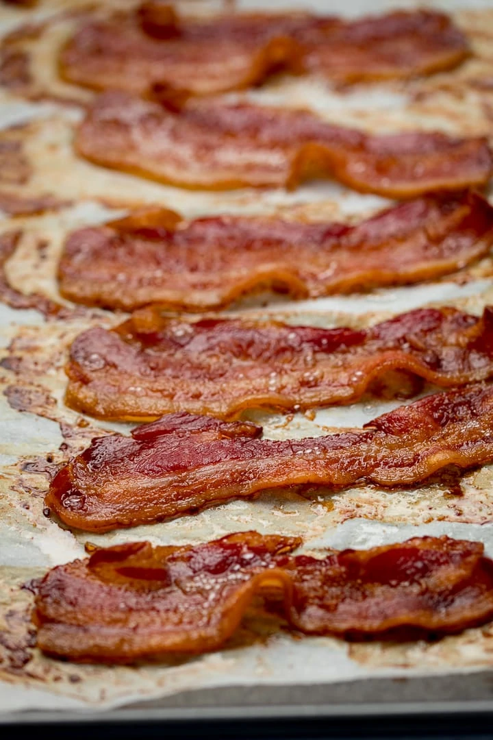 cooked bacon on a tray lined with parchment