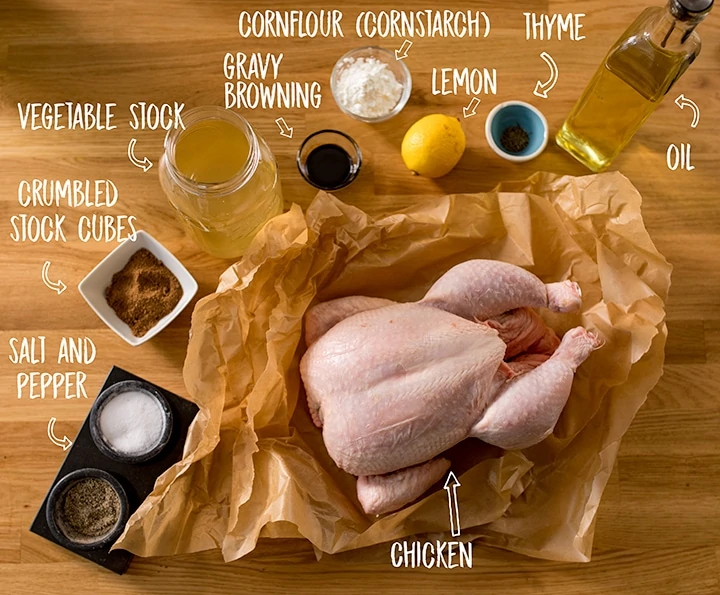 Ingredients for roast chicken and gravy on a wooden table