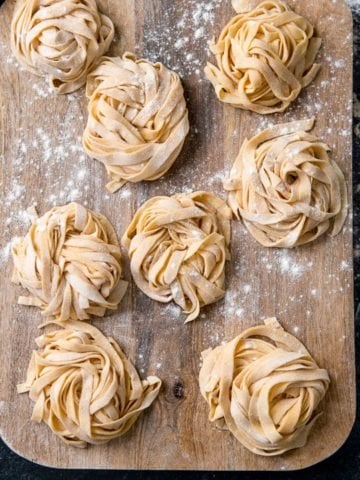 Little piles of homemade pasta on a wooden board