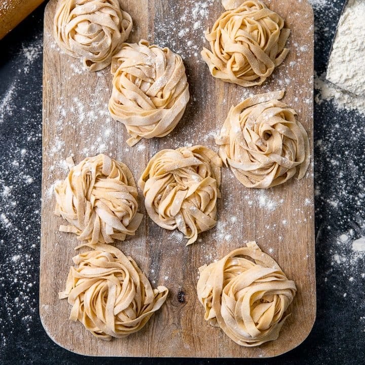 Little piles of homemade pasta on a wooden board