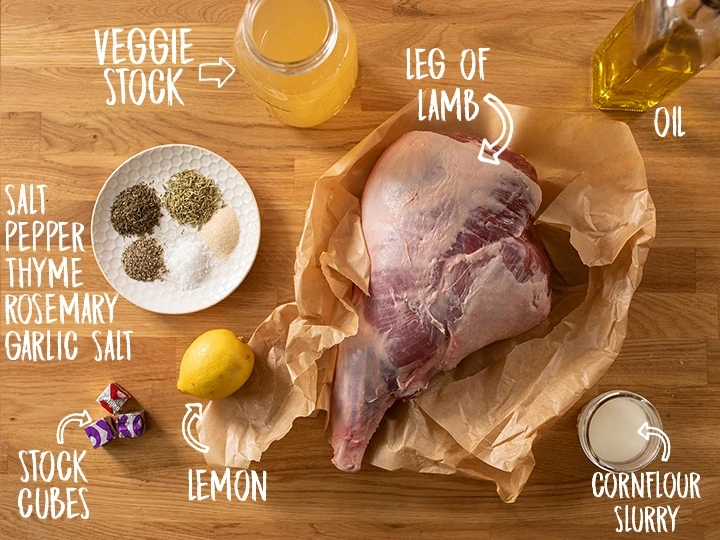 Ingredients for roast leg of lamb with gravy on a wooden table