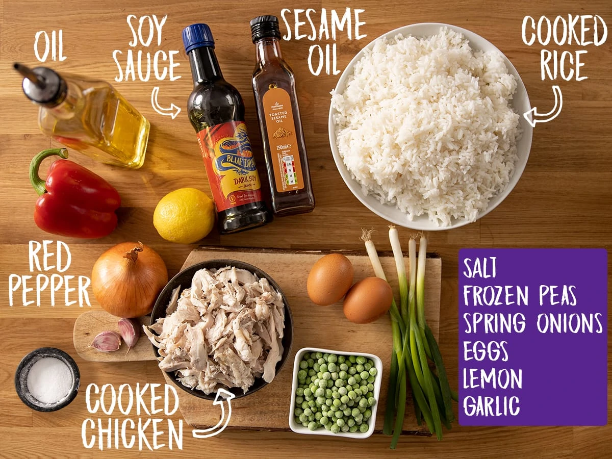 Ingredients for Chicken Fried Rice on a wooden table