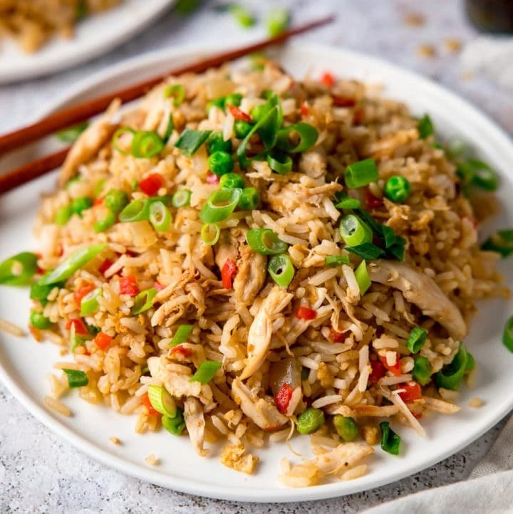 Chicken Fried Rice on a white plate topped with spring onions