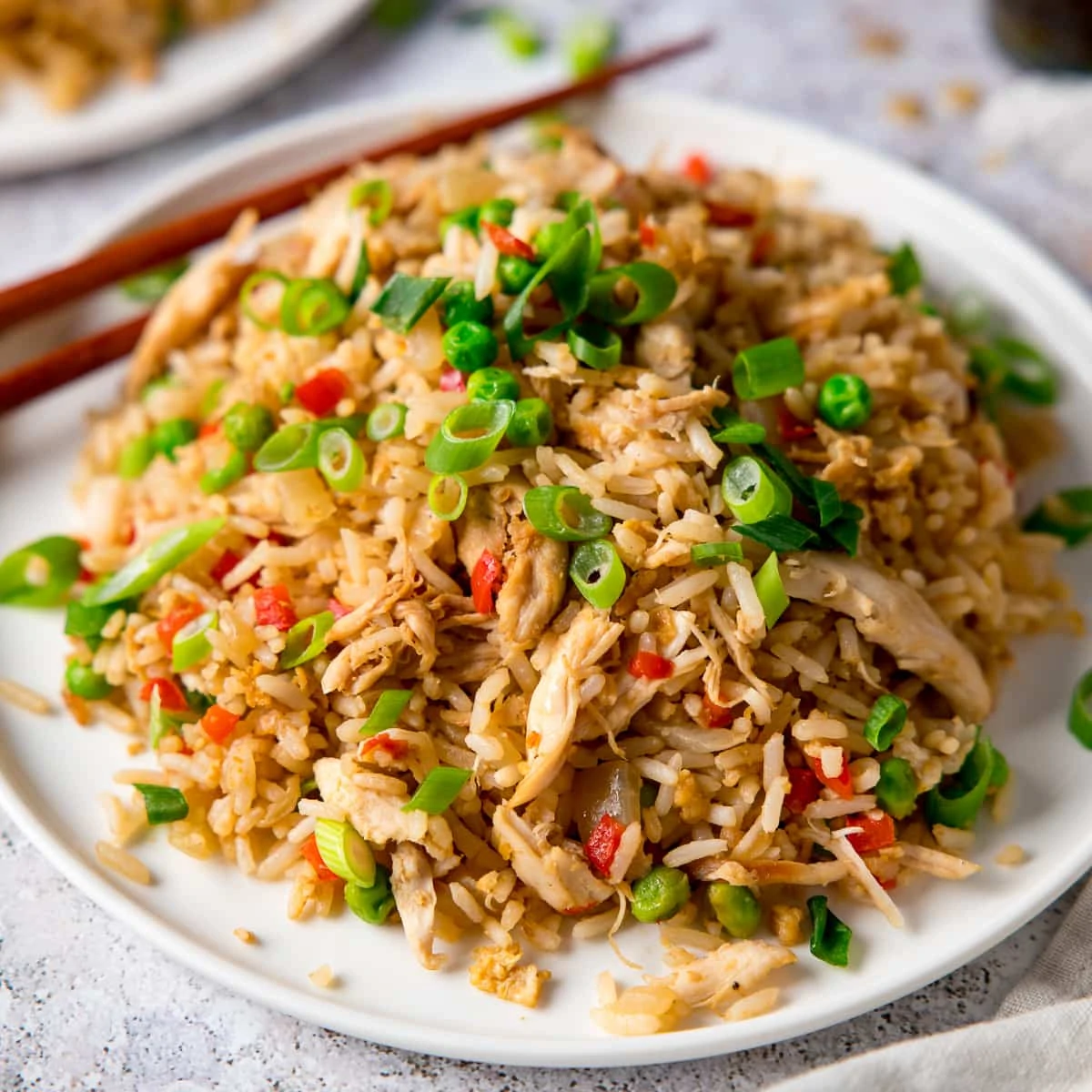 Chicken Fried Rice on a white plate topped with spring onions