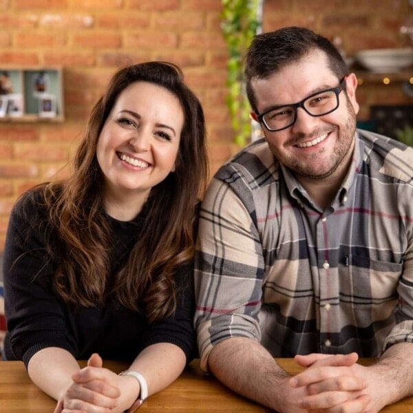 Chris and Nicky Corbishley in their kitchen with a brick wall in the background