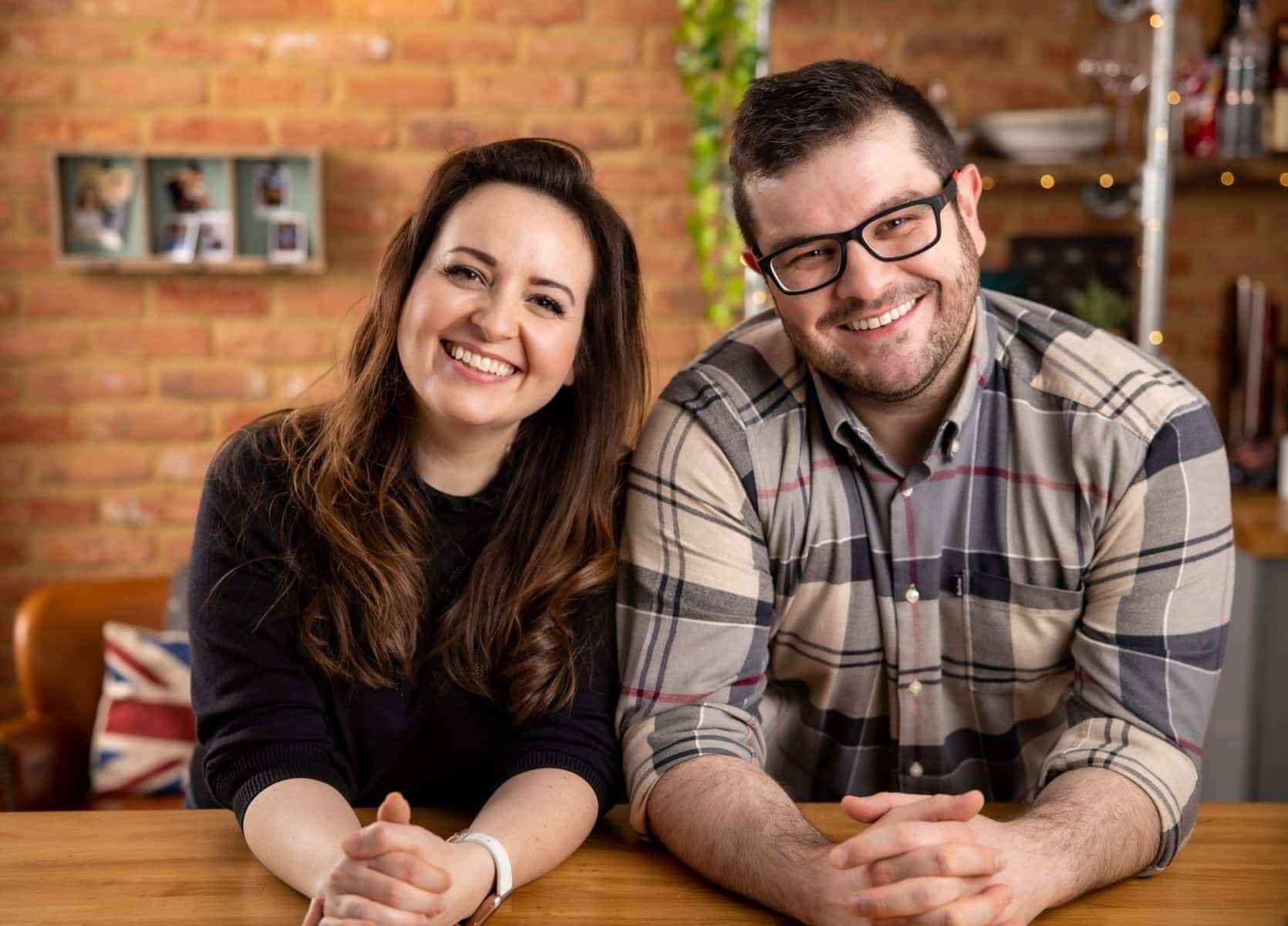 Picture of Chris and Nicky Corbishley in their kitchen with a brick wall in the background.