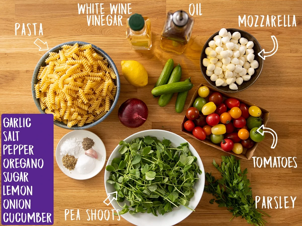 Ingredients for pasta salad on a wooden table
